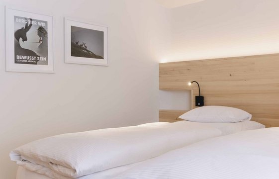 Bett in der Wohnung im Hotel Aurora Bett in der Wohnung im Hotel Aurora